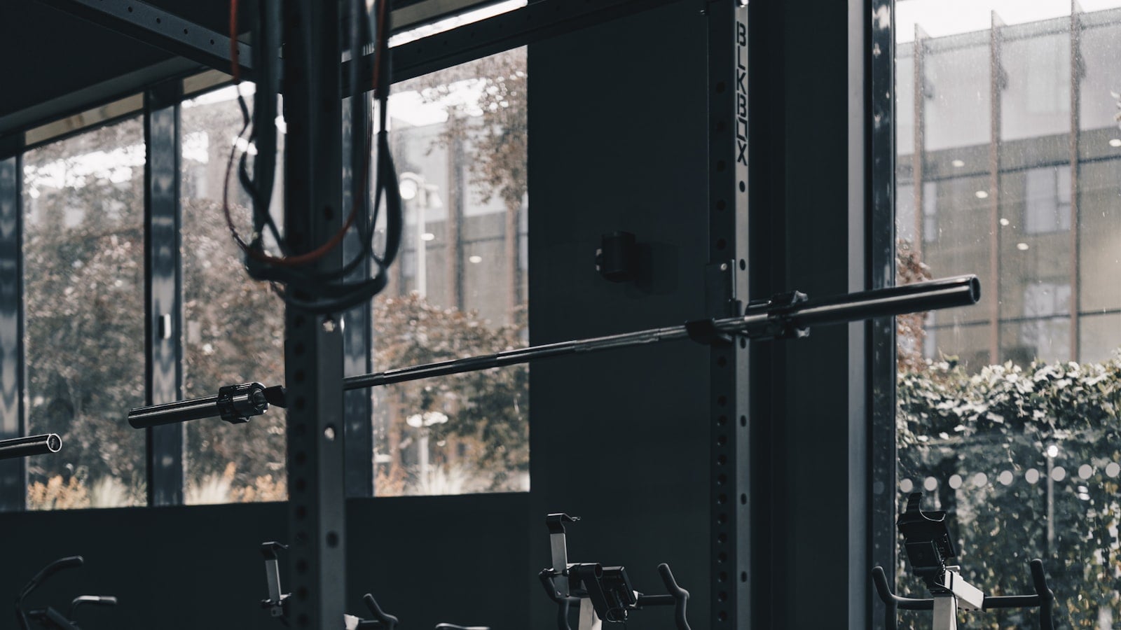 An empty gym floor with a row of exercise machines (photo: Ambitious Studio | Rick Barrett / Unsplash)