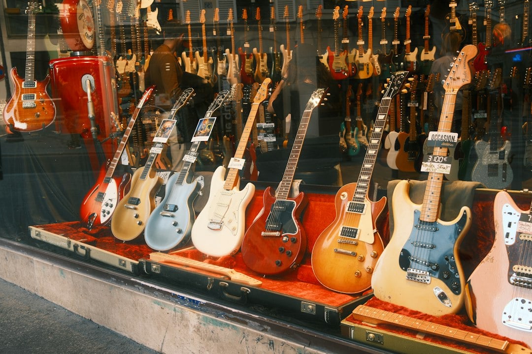 Vintage electric guitars lying in open cases in a music store window display