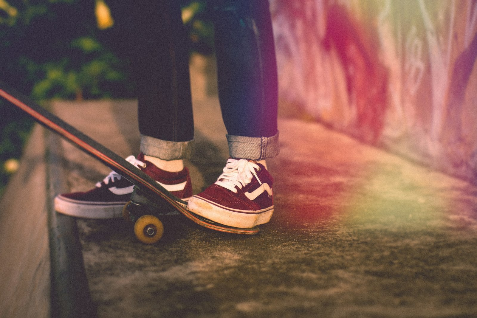 Red low-top skate shoes on a skateboard (photo: Rhendi Rukmana / Unsplash)