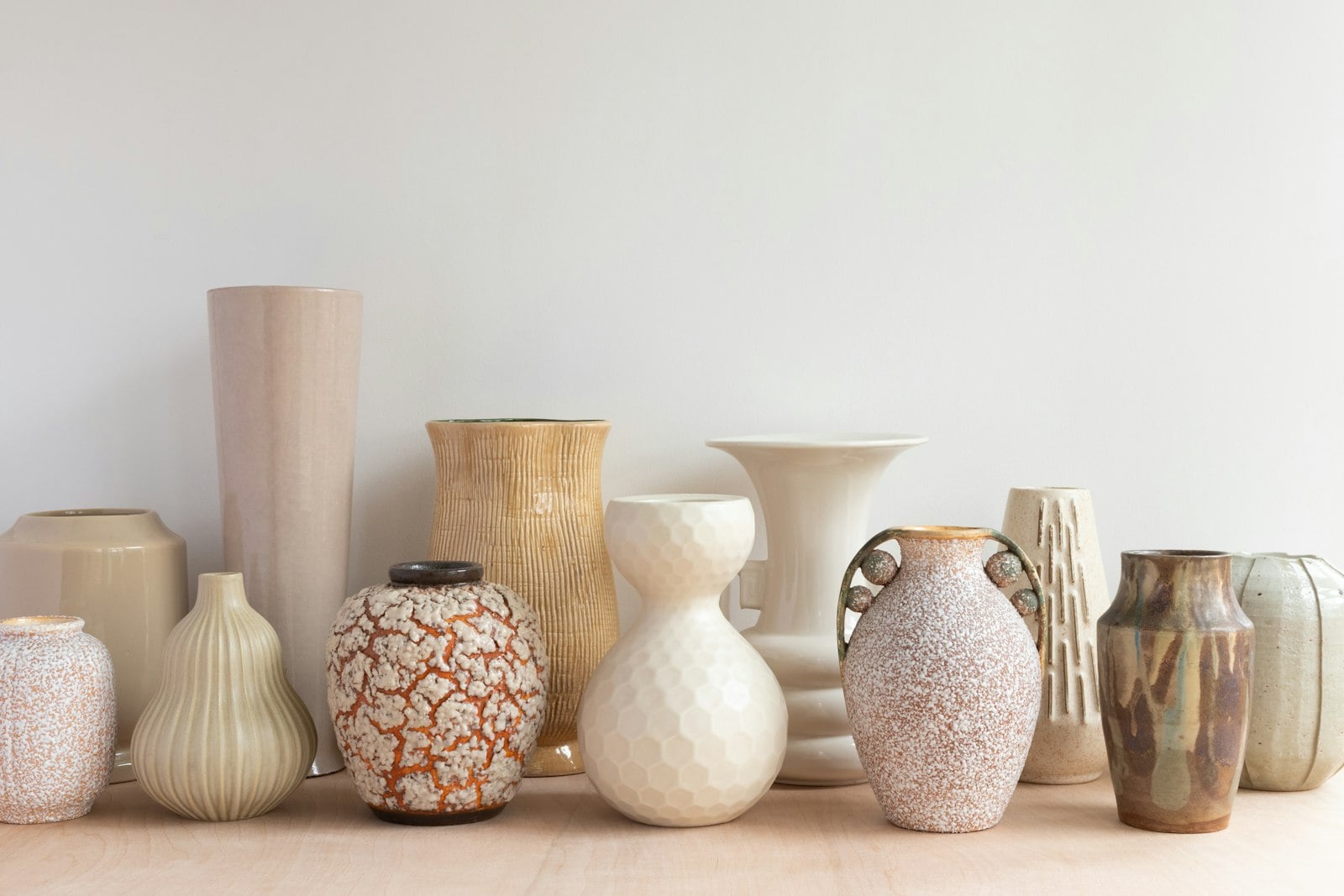 Row of vintage ceramic vases in cream and earth tones (photo: Chloe Bolton / Unsplash)